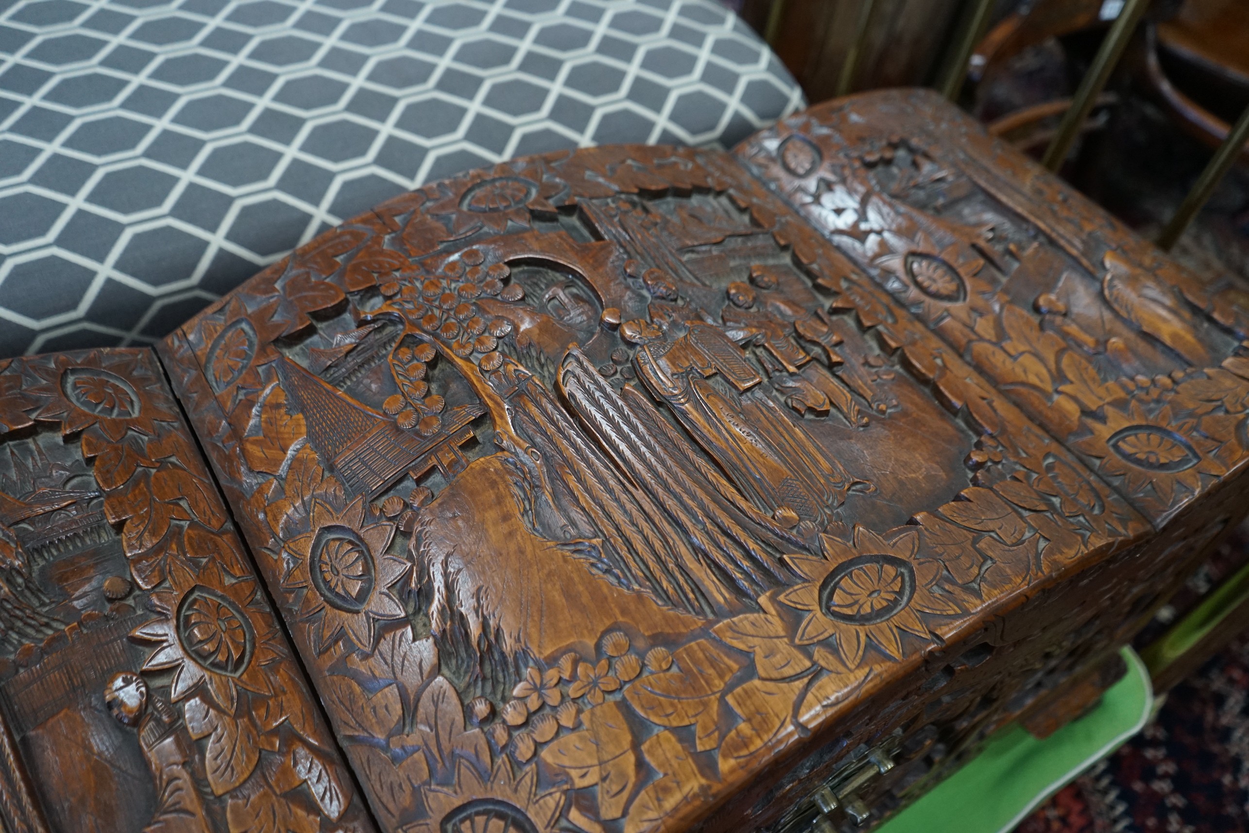 A Chinese carved camphorwood coffer with domed cover, length 93cm, depth 43cm, height 55cm